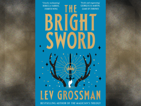 Cover art for The Bright Sword by Lev Grossman. Shows a prominent antlers, between them is a white hand holding a black sword and golden grown. The cover is a light blue with golden yellow text.